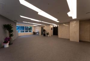 an empty office with a large room with plants at Hotel Diamant in Seoul