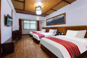 Posteľ alebo postele v izbe v ubytovaní Zhangjiajie Wulingju Hotel