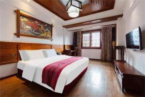 Televízia a/alebo spoločenská miestnosť v ubytovaní Zhangjiajie Wulingju Hotel