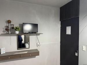 a television on a shelf in a room at El Hostalito Metepec in Toluca