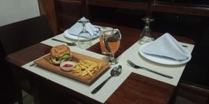 a table with a sandwich and french fries and a glass of wine at Rue DeuxVilles Villa in Loon