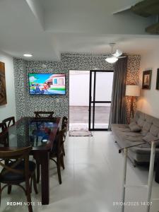 a living room with a couch and a table at Triplex em Caiobá-Matinhos-Pr a 200 mt do mar in Matinhos +52 photos