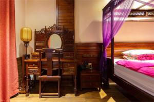 Posteľ alebo postele v izbe v ubytovaní Zhangjiajie Wulingju Hotel