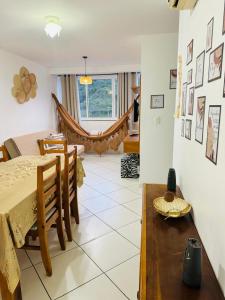 ein Wohnzimmer mit Tisch und ein Esszimmer in der Unterkunft Apartamento prainha rua da praia in Arraial do Cabo