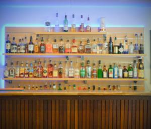 a shelf filled with lots of bottles of alcohol at Manjimup Gateway Hotel in Manjimup