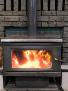 a stove with a fire inside of it at Manjimup Gateway Hotel in Manjimup