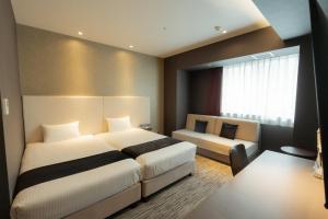 Katil atau katil-katil dalam bilik di Hotel Aqua Citta Naha