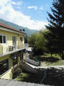 a view of a house with a balcony and a yard at Hotel Paradise in Bruzolo