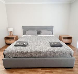 a bedroom with a bed with two pillows on it at Manjimup Gateway Hotel in Manjimup