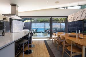 a kitchen and dining room with a table and chairs at Aspen Grove by Sotheby's Luxury Rental Homes in Queenstown
