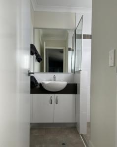 a bathroom with a sink and a mirror at Manjimup Gateway Hotel in Manjimup