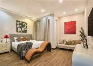 a bedroom with a large bed and a couch at Cloud Passion Airport Hotel in Ho Chi Minh City