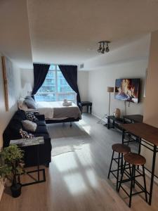 a living room with a bed and a couch at Downtown Toronto Cozy Suite in Toronto