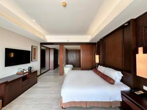 a bedroom with a large bed and a television at Crowne Plaza Danang Hotel & Resort in Da Nang +147 photos