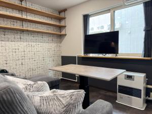 a table and chairs in a room with a window at エクセル北円山 in Sapporo