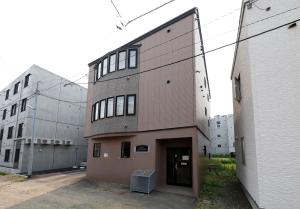 a tall brick building with a door in the middle at エクセル北円山 in Sapporo