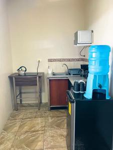 a kitchen with a sink and a counter with a coffee maker at Kicker Suite in Puerto Baquerizo Moreno +19 photos