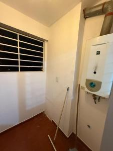 an empty room with a window and a refrigerator at Departamento en Salta Capital in Salta
