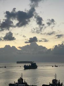 a group of boats in the water at sunset at Port Said Luxury Marina Stay in Port Said