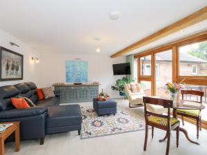 a living room with a couch and a table at Sylva Cottage in Shrewsbury