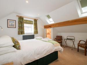 a bedroom with a large bed and a window at Sylva Cottage in Shrewsbury