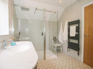 a white bathroom with a sink and a shower at Sylva Cottage in Shrewsbury +23 photos