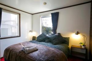 a bedroom with a large bed with a window at Kilimanjaro Alpine Apartments in Falls Creek