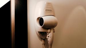 a hair dryer is attached to a wall at Casa Nostra in Quito