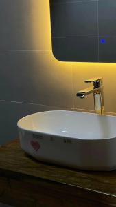 a white sink sitting on a counter in a bathroom at Paàng Village - Thiên đường mây Tà Xùa in Bắc Yên