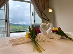ein Bett mit zwei Herzen und Blumen drauf in der Unterkunft กาแฟอาลูลูดอยล้าน in Mae Suai