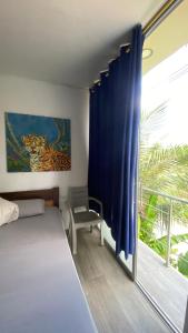 a bedroom with a bed and a large window at Amazonas magic in Leticia
