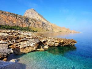 a view of a beach with rocks in the water at House in Sicily near beaches in Siracusa