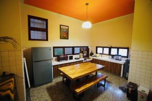 a kitchen with a wooden table and a refrigerator at Liu Xu Homestay in Tainan