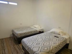 Postel nebo postele na pokoji v ubytování Hostal nancy