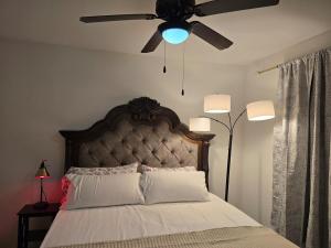 a bedroom with a bed with a ceiling fan at Frisco Getaway in Frisco +31 photos