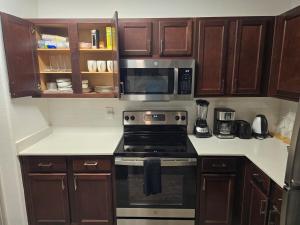 a kitchen with a stove and a microwave at Frisco Getaway in Frisco
