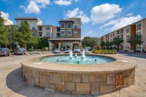 a fountain in a circle in front of a building at Frisco Getaway in Frisco