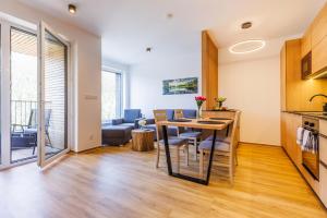 a kitchen and living room with a table and chairs at Apartmán Jako doma in Dolní Morava +4 photos