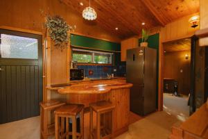 a kitchen with a counter and a refrigerator at Mangamaunu Cottage in Kaikoura