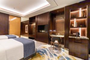 a hotel room with a bed and a desk at Arjuna Solitaire Hotel in Sihanoukville