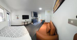 a living room with a couch and a television at Alpin Motel & Conference Centre in Rotorua