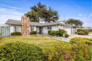 a large white house with a large yard at STR25-15 Master Bedroom Marina in Marina