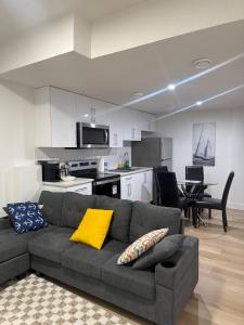 a living room with a couch and a kitchen at Amazing 2-bedroom house with WiFi in Edmonton in Edmonton