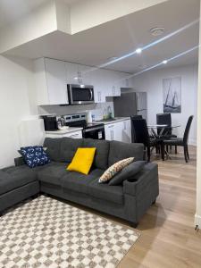 a living room with a couch and a kitchen at Amazing 2-bedroom house with WiFi in Edmonton in Edmonton +30 photos