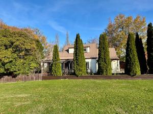 a house with a row of trees in a yard at 25 Leamington Street in Hanmer Springs