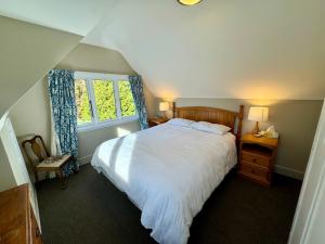 a bedroom with a large bed and a window at 25 Leamington Street in Hanmer Springs