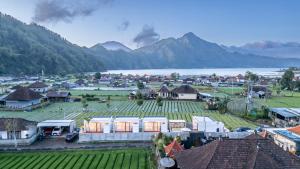 a village with mountains and a body of water at Heaven House Kintamani in Kubupenlokan