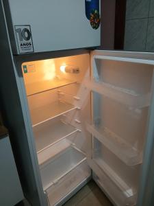 an empty refrigerator with its door open with its door open at Casa Região Central! Próximo a Igreja, pontos turísticos 2 quartos in Aparecida