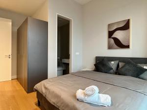 a bedroom with a bed with towels on it at KL Central 31st floor KLCC view in Kuala Lumpur