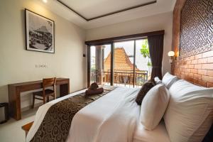 a bedroom with a large white bed with a window at Pendopo Canggu Village in Canggu +72 photos